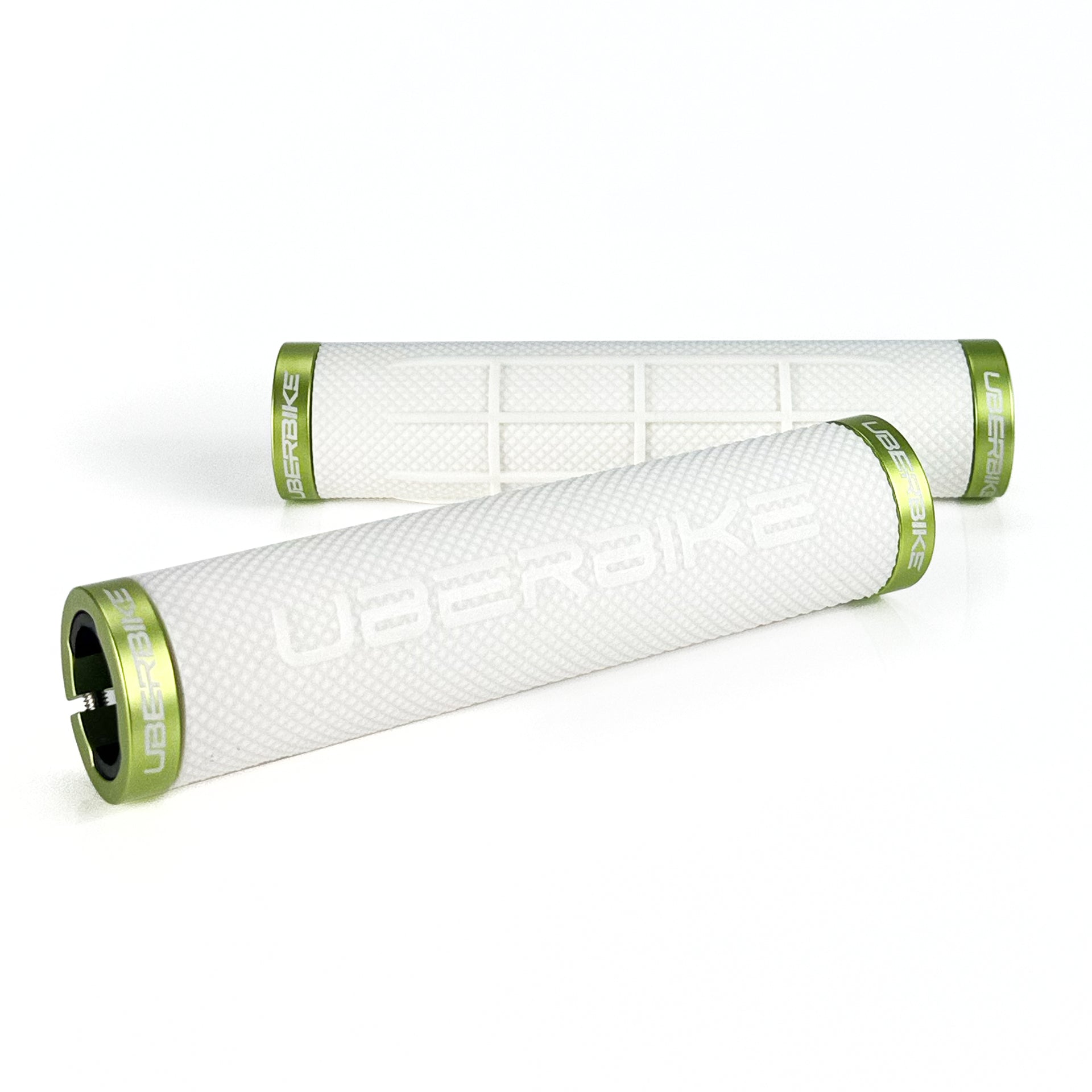 two white fat grip mountain  bike grips and green lockrings on a white background