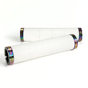 two white fat grip mountain  bike grips and oil slick lockrings on a white background