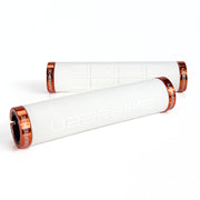 two white fat grip mountain  bike grips and orange lockrings on a white background