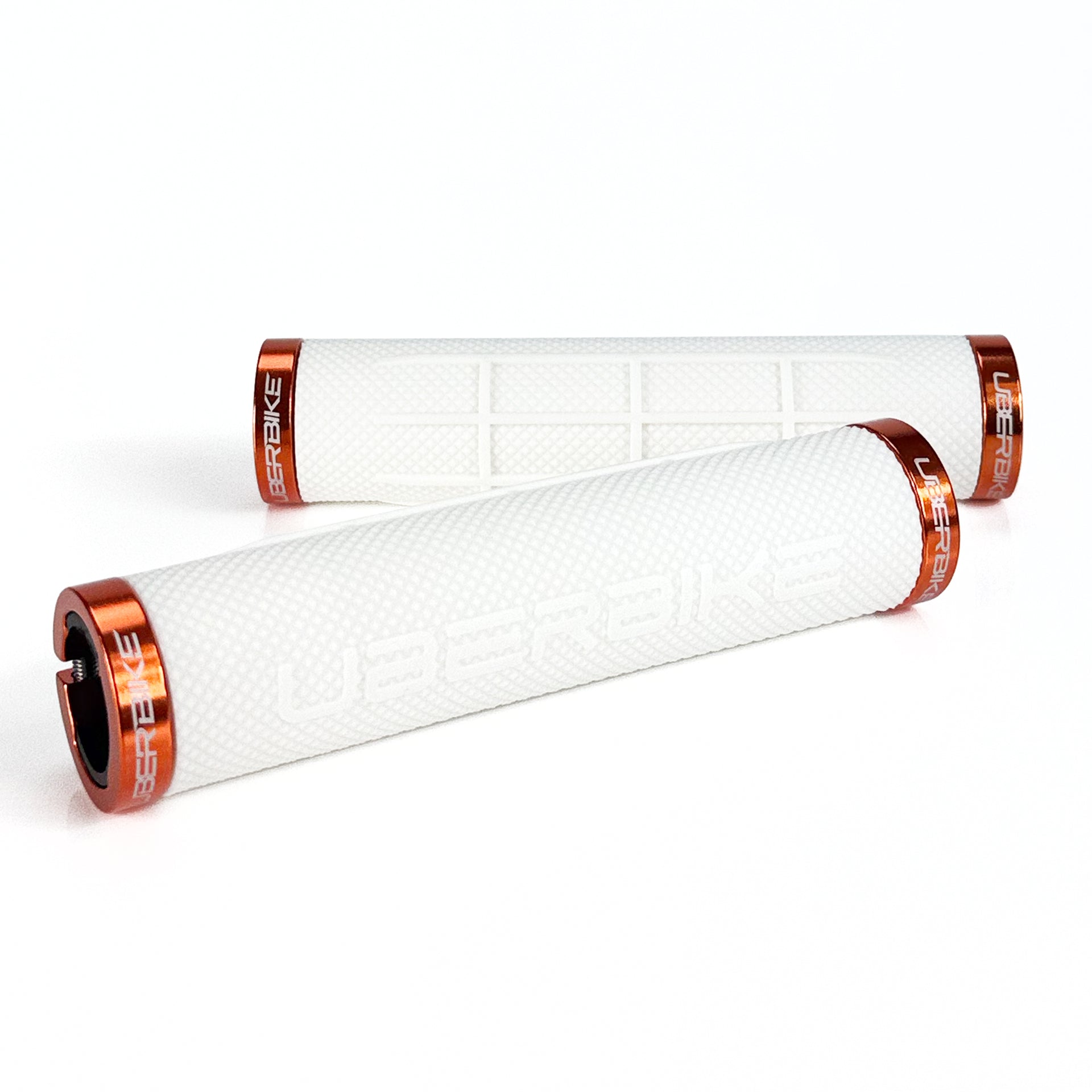 two white fat grip mountain  bike grips and orange lockrings on a white background