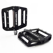 Black flatout bicycle pedals with 'Uberbike' branding on a white background