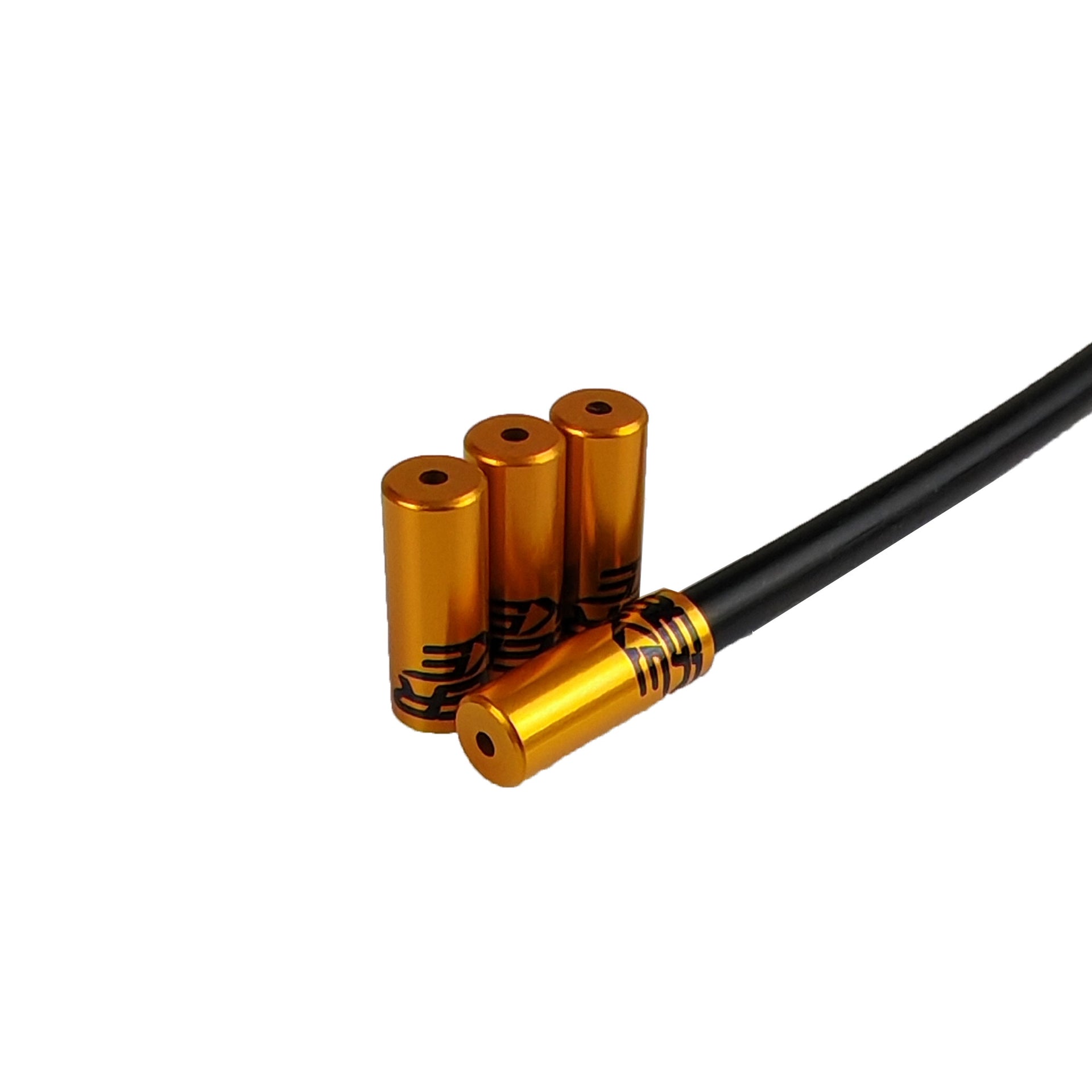 gold Uberbike branded gear ferrules on a white background