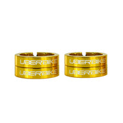 Four gold bicycle lock on rings with 'UberBike' branding on a white background