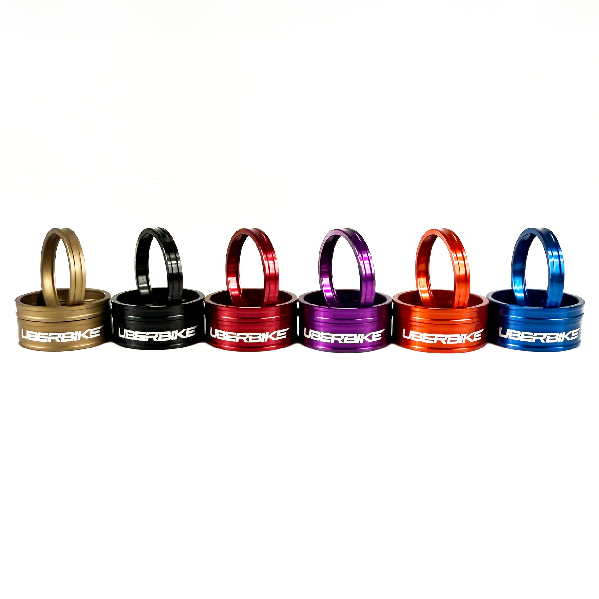 Headset spacers in a range of colours with Uberbike branding on a white backtground