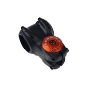 orange headset top cap with a bronze bolt with uberbike branding on a white background