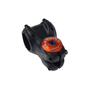 orange headset top cap with an oil slick bolt with uberbike branding on a white background