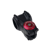 red headset top cap with a raw bolt with uberbike branding on a white background