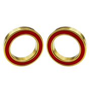 Two gold-toned ceramic bottom bracket bearing for Hollowtech 2 with a red inner ring, shown side by side on a plain white background