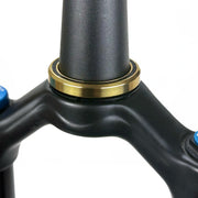 gold titanium lower bearing on a handlebar stem on a white backgroud