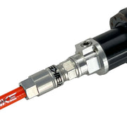 orange reverb hose installed in a dropper post on a white background