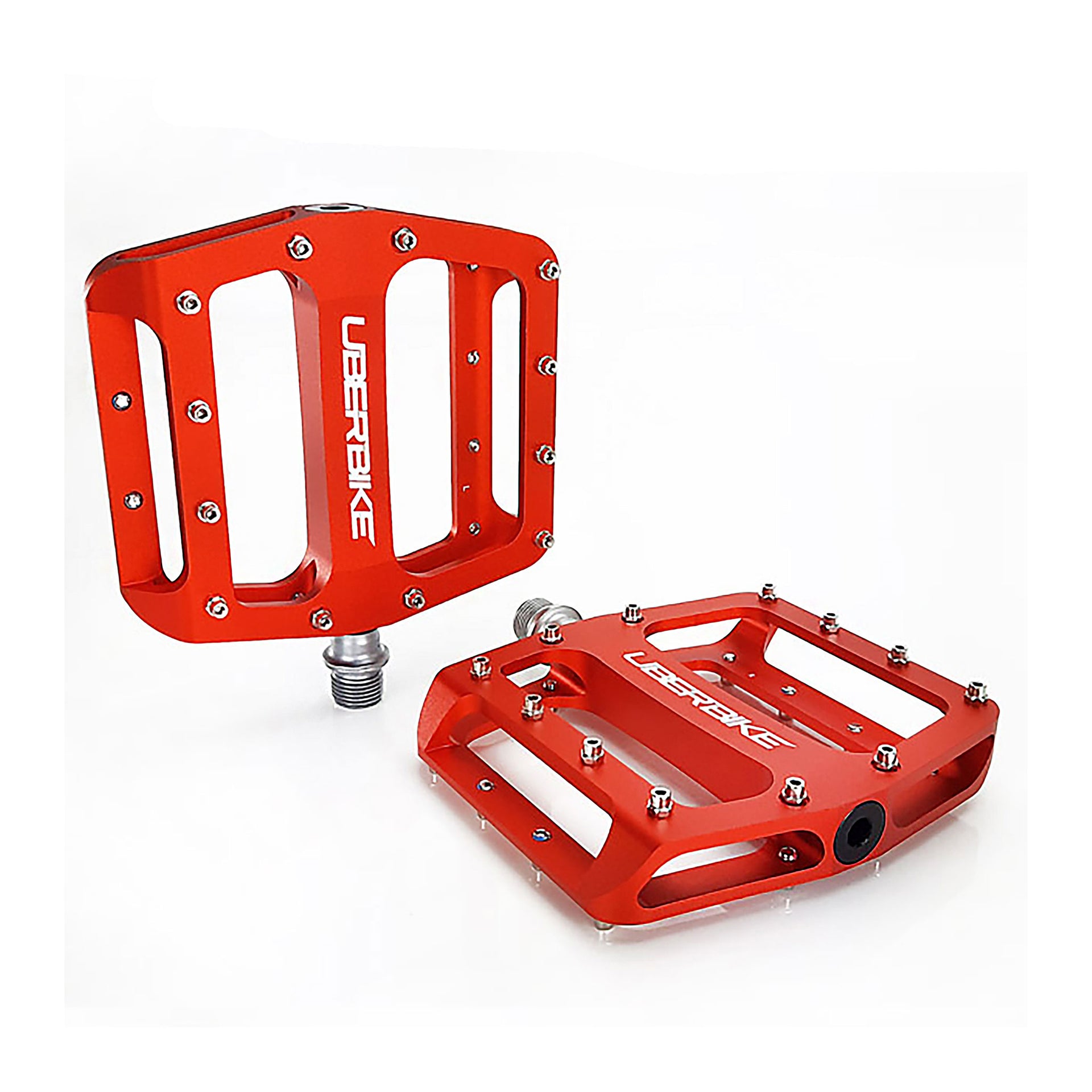 orange flatout mtb pedals with Uberbike branding on a white background