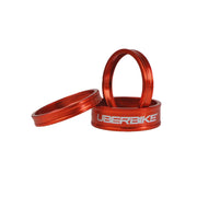 3 orange headset spacers with Uberbike branding on a white background