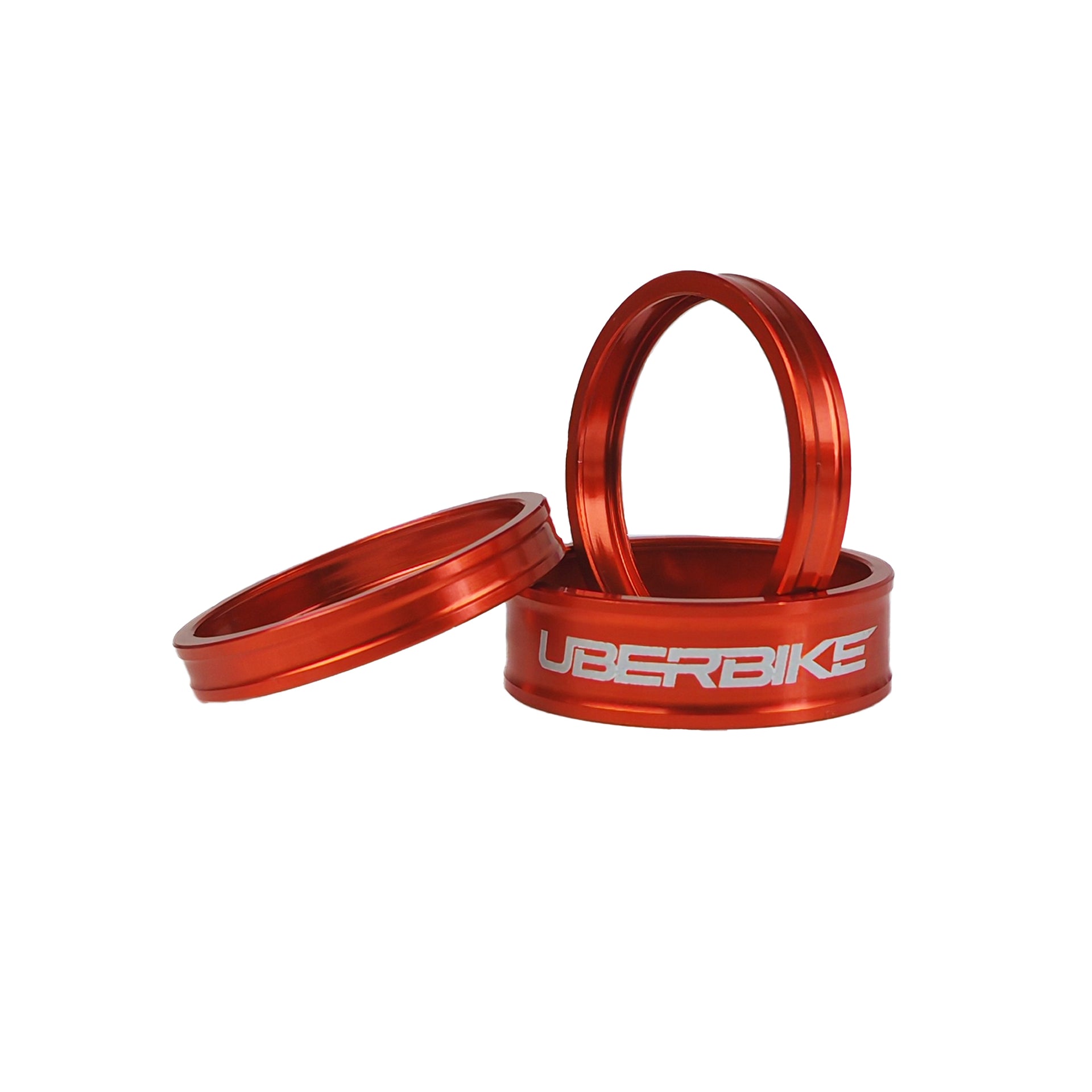 3 orange headset spacers with Uberbike branding on a white background