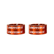 Four orange bicycle lock on rings with 'UberBike' branding on a white background