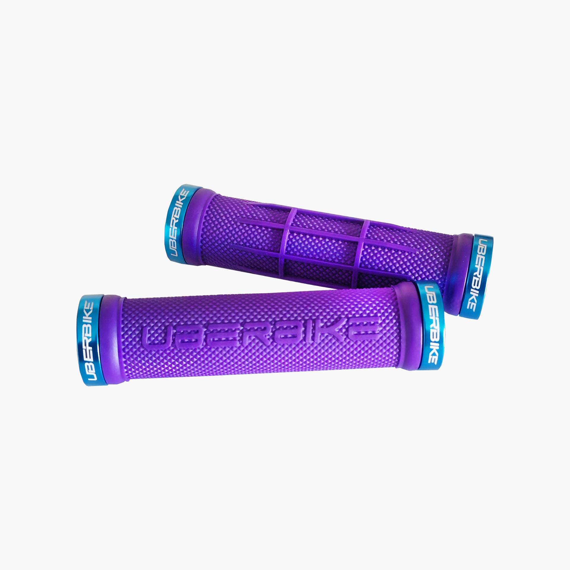 2 purple half waffle mountain bike grips with blue lockrings and uberbike branding on a white background
