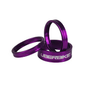3 pruple headset spacers with Uberbike branding on a white background