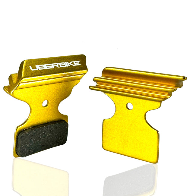 Shimano XTR gold polar tech brake pads on a white background