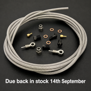 A coiled light silver braided shimano xtr brake cable with several small metal hardware components arranged on a dark textured surface. White text at the bottom reads 'Due back in stock 14th September'.
