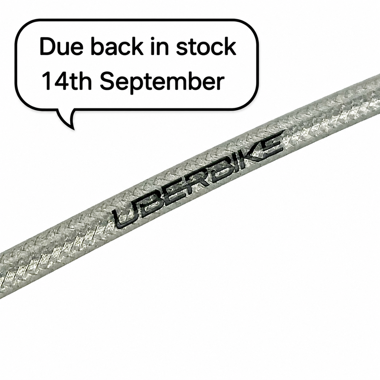 A close-up of a silver braided SRAM silver cable with the brand name 'UBERBIKE' printed on it, set against a plain white background with a speech bubble stating 'Due back in stock 14th September'.
